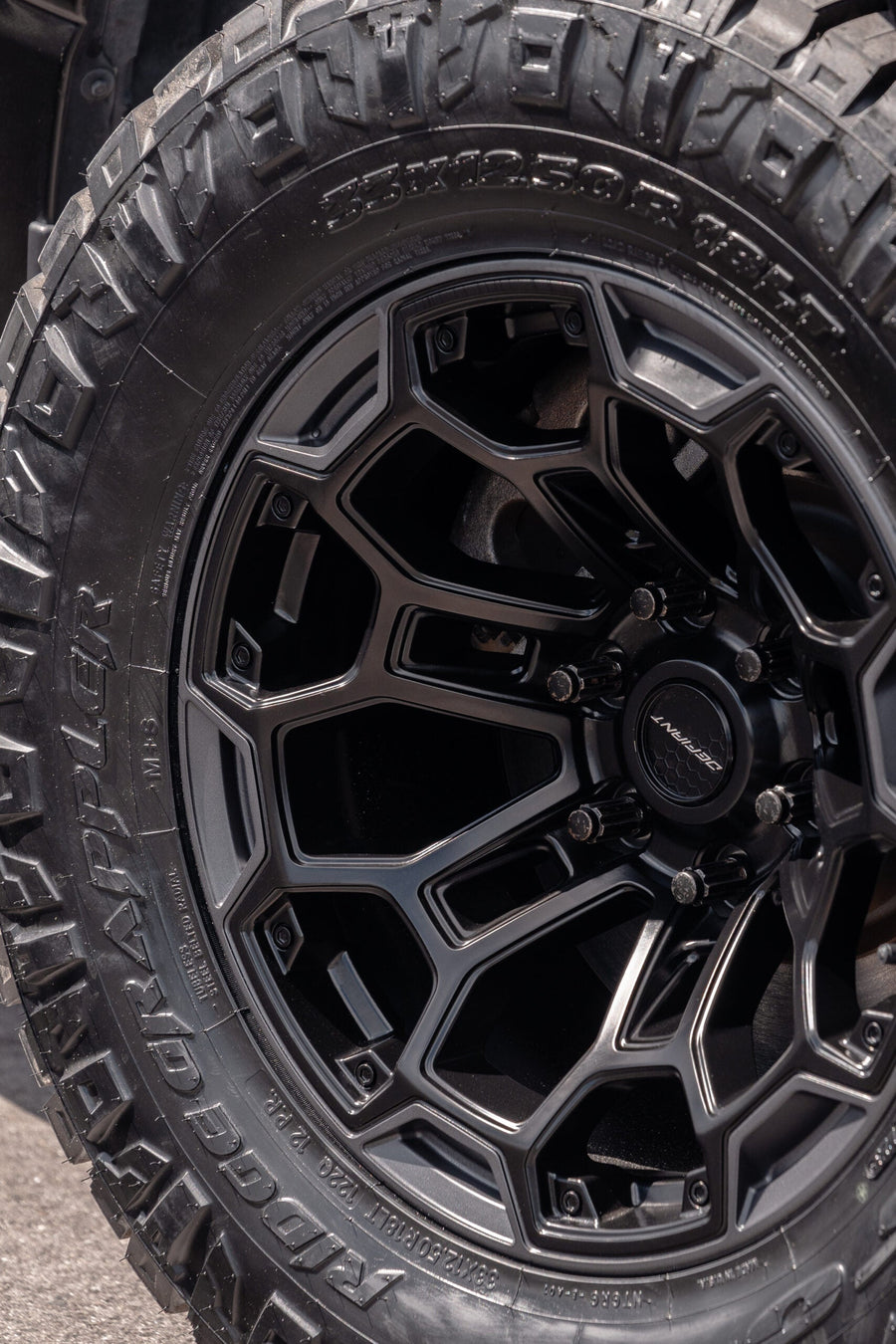 RAM 1500 DEFIANT WHEELS DF03 18X9 33X12.5X18 NITTO TIRES STOCK SUSPENSION
