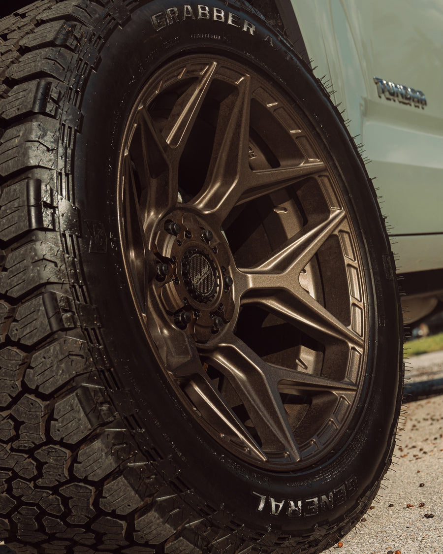 ’24 Toyota Tundra on our New 4P06 Bronze Finish with a 275-50-20 Tire on Stock Suspension